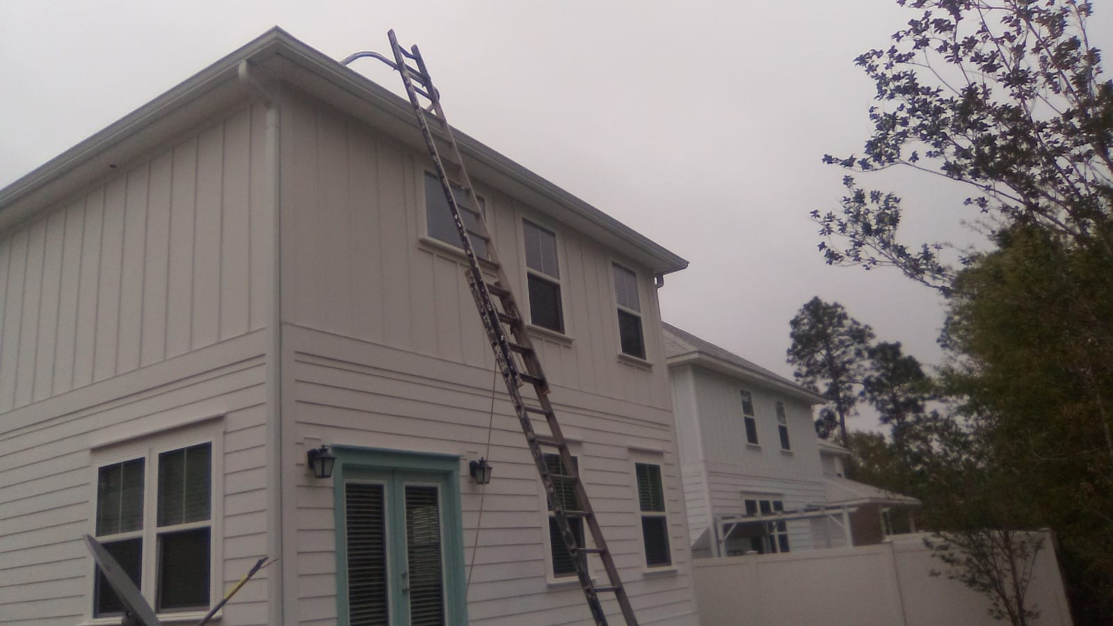 Gutter installation on a two-story home exterior