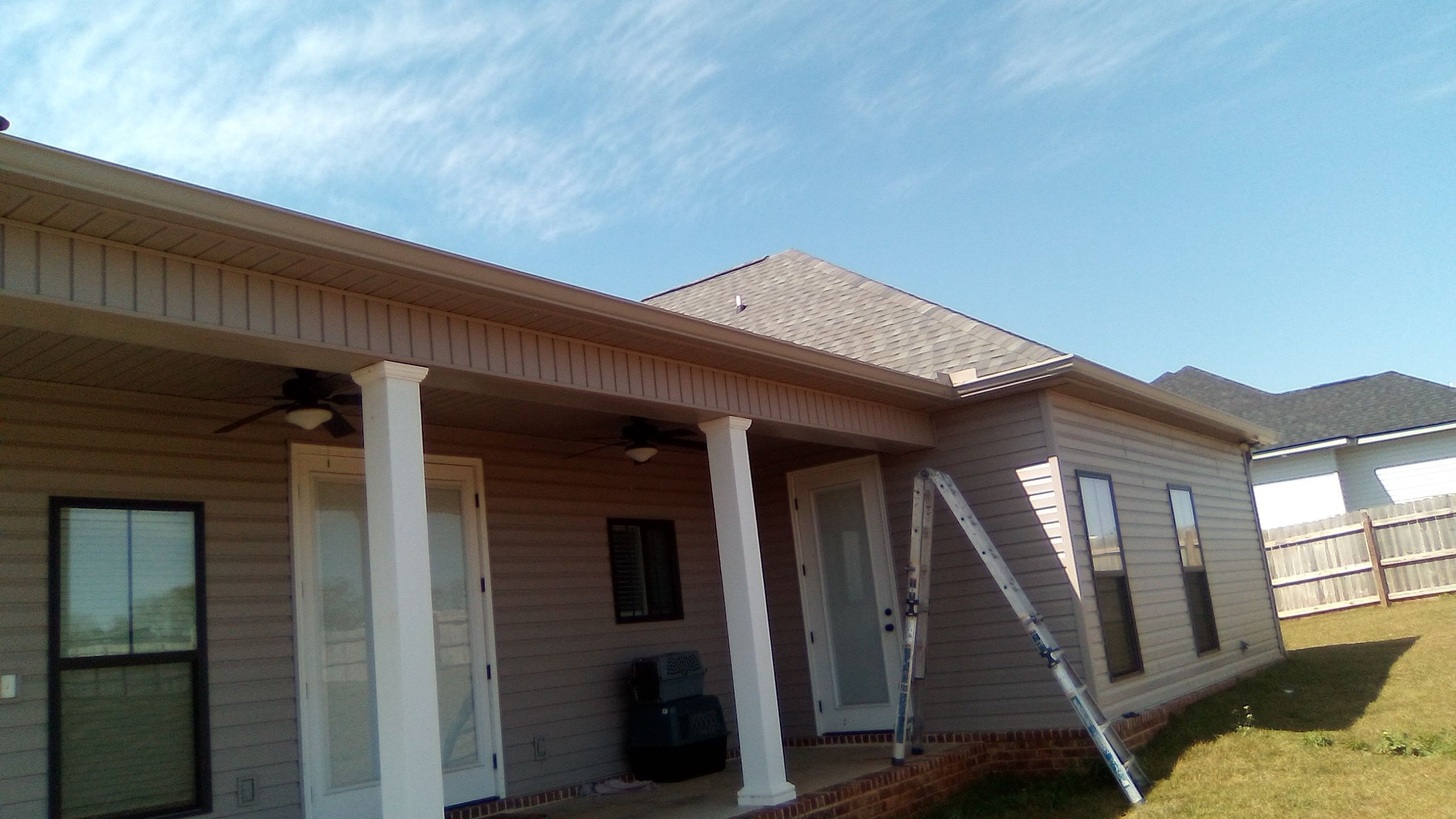 Seamless gutters installed along a residential roofline