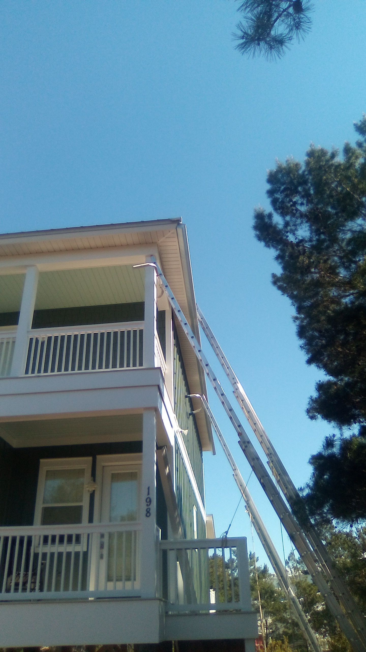 Gutter installation underway on a two-story home