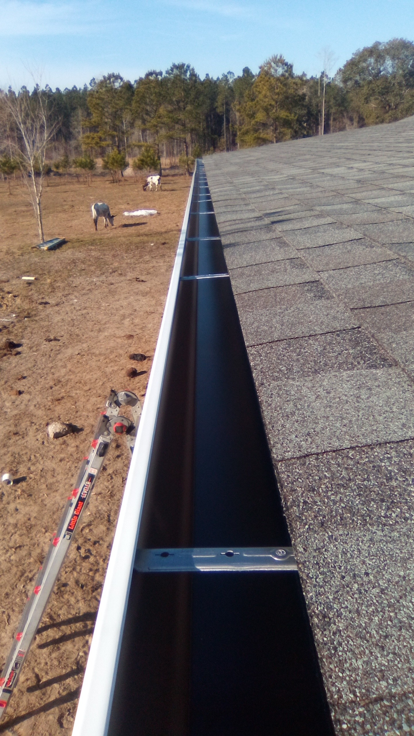 Gutter line installed along a rural property roof