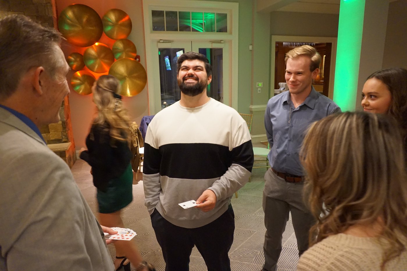 Guests smiling during a close-up magic moment at a company event