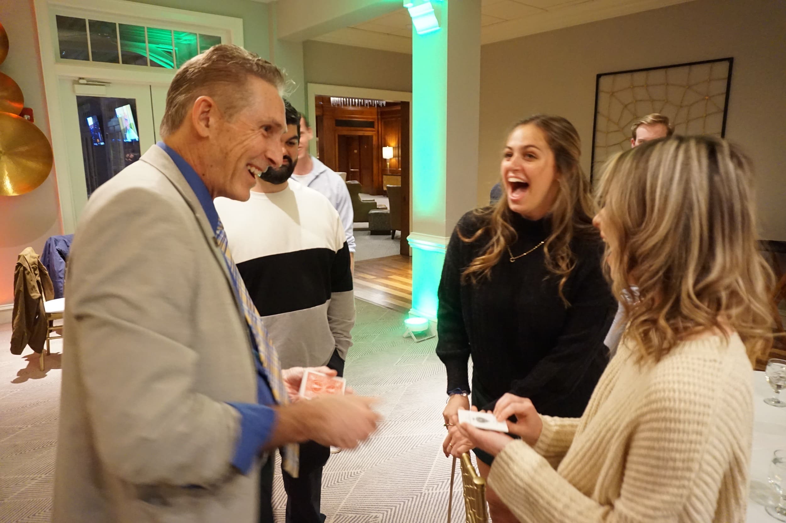 Zelnik performing close-up magic with guests