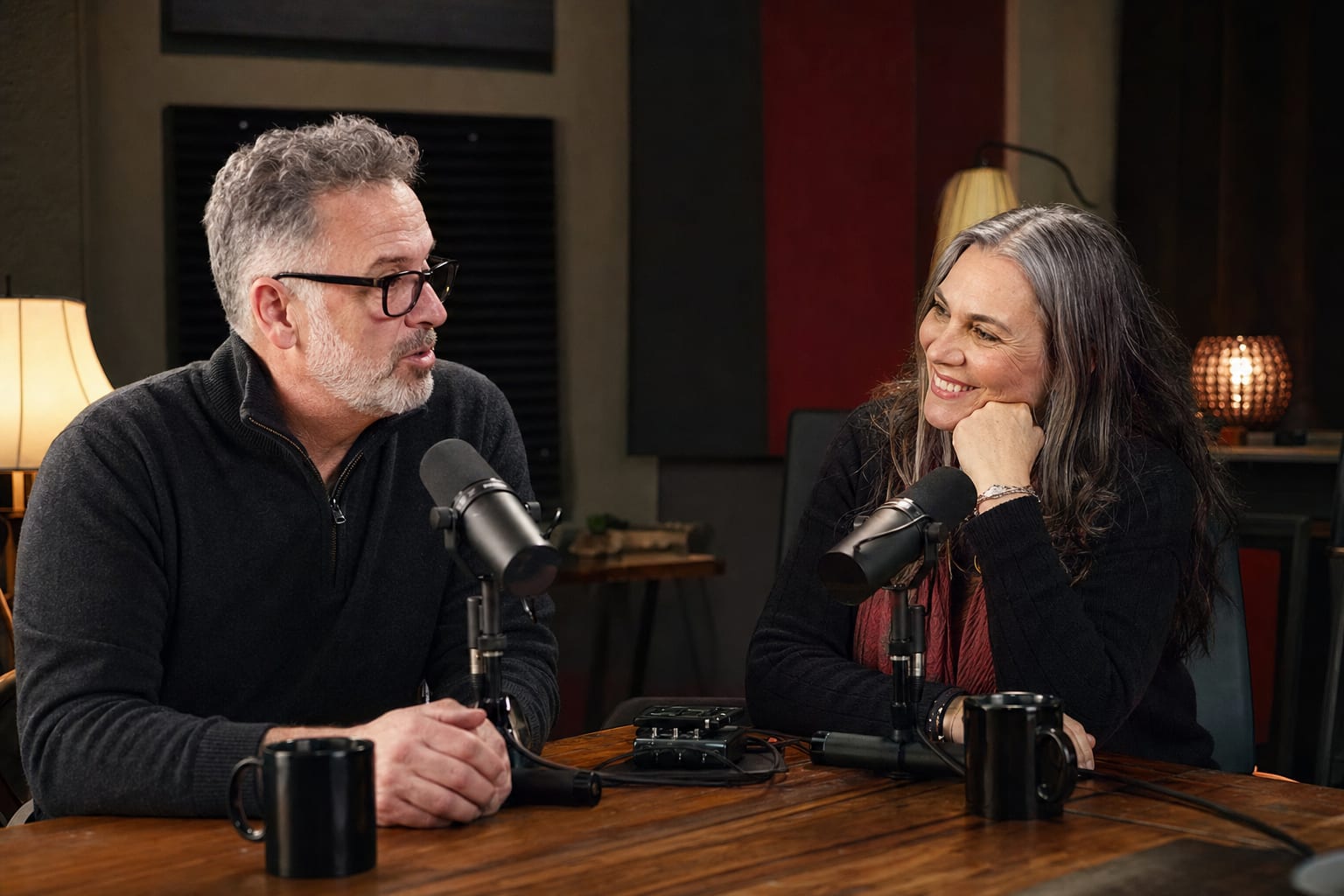 Podcast host and guest listening closely during a friendly recording session