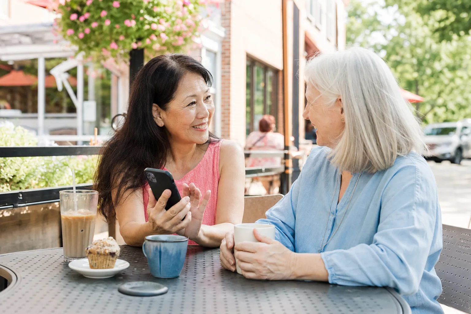 Two friends sharing a local business recommendation at a cafe