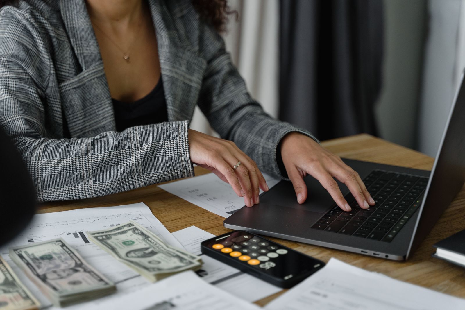 Person reviewing financial papers and a calculator at a desk