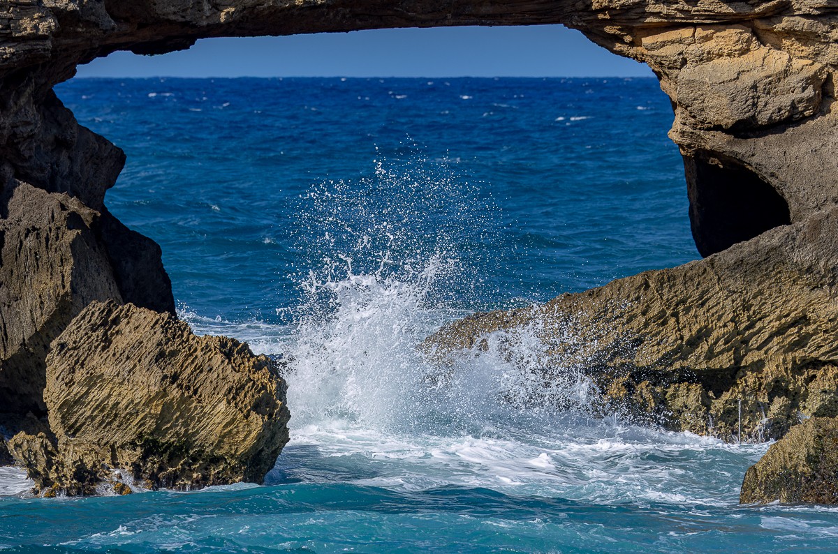 Ocean surf through a rocky opening in Hawaii, photographed by Susanne Harm