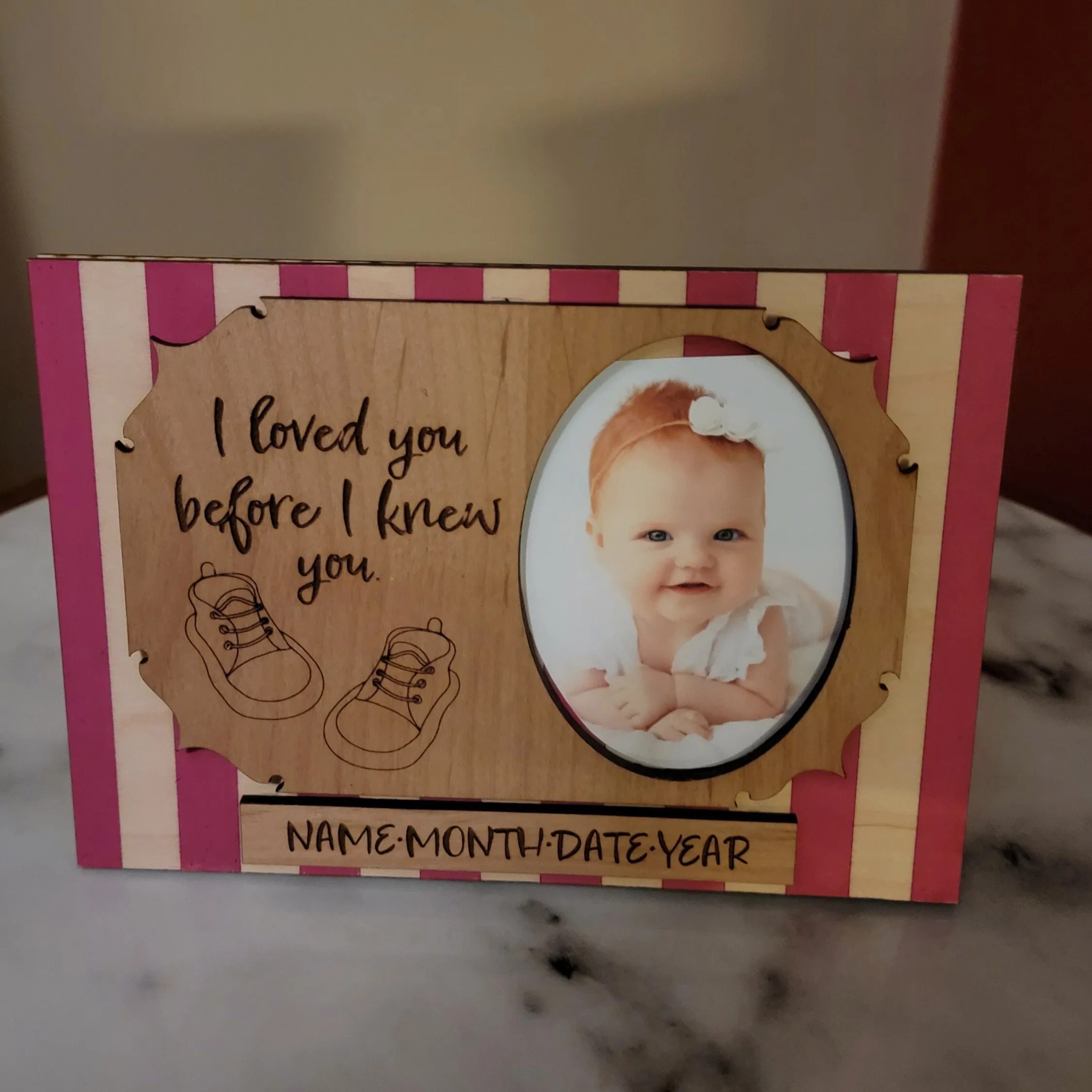 Personalized wooden baby picture frame displayed upright