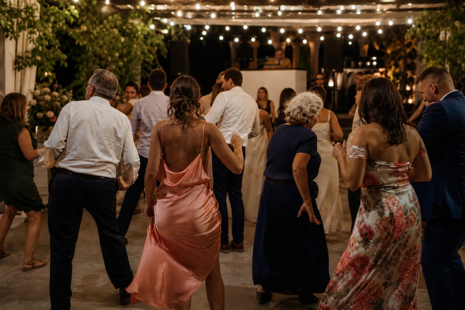 Guests dancing together at an evening wedding reception