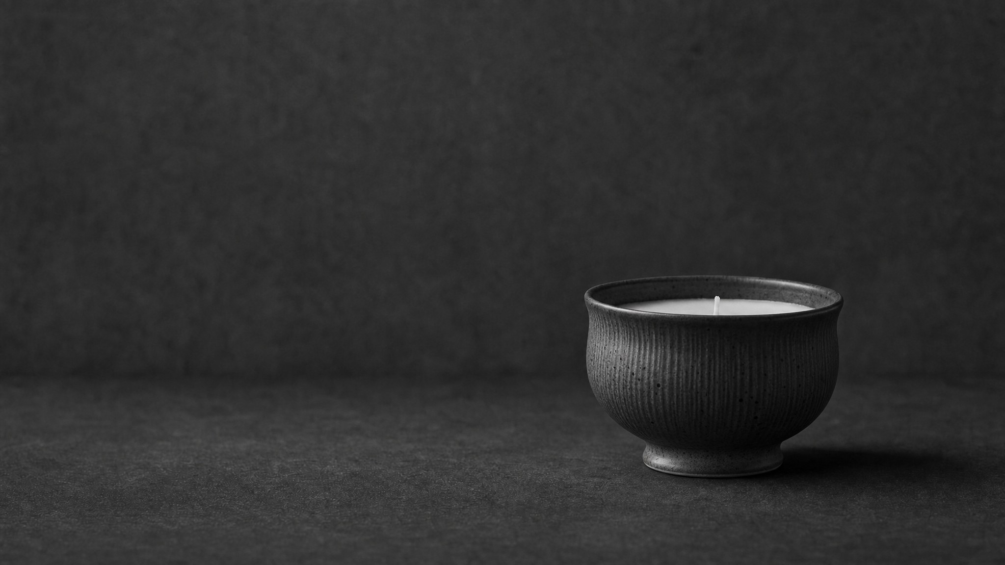 A hand-poured candle set in a warm home.