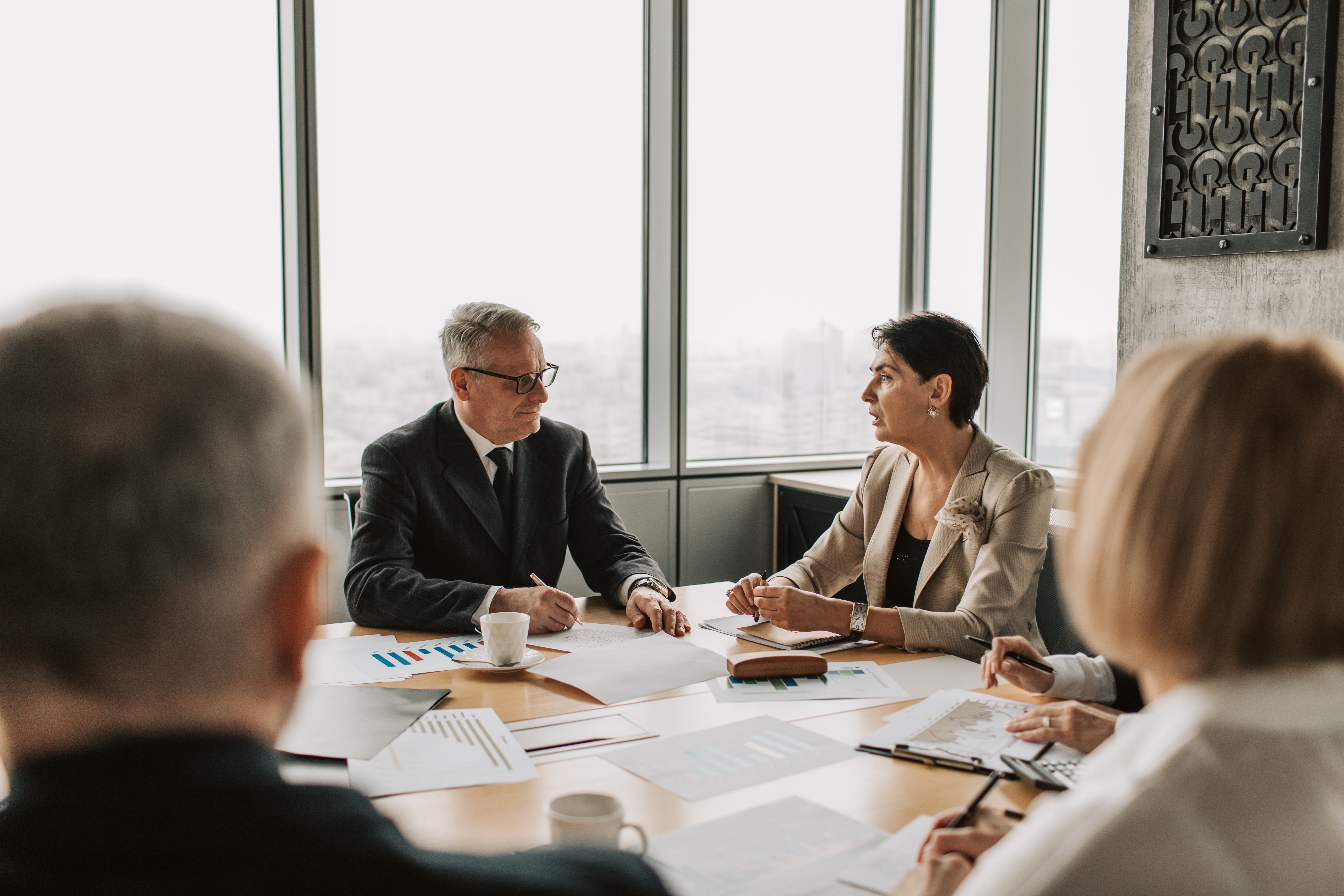 Senior leaders in a focused strategy conversation around a meeting table