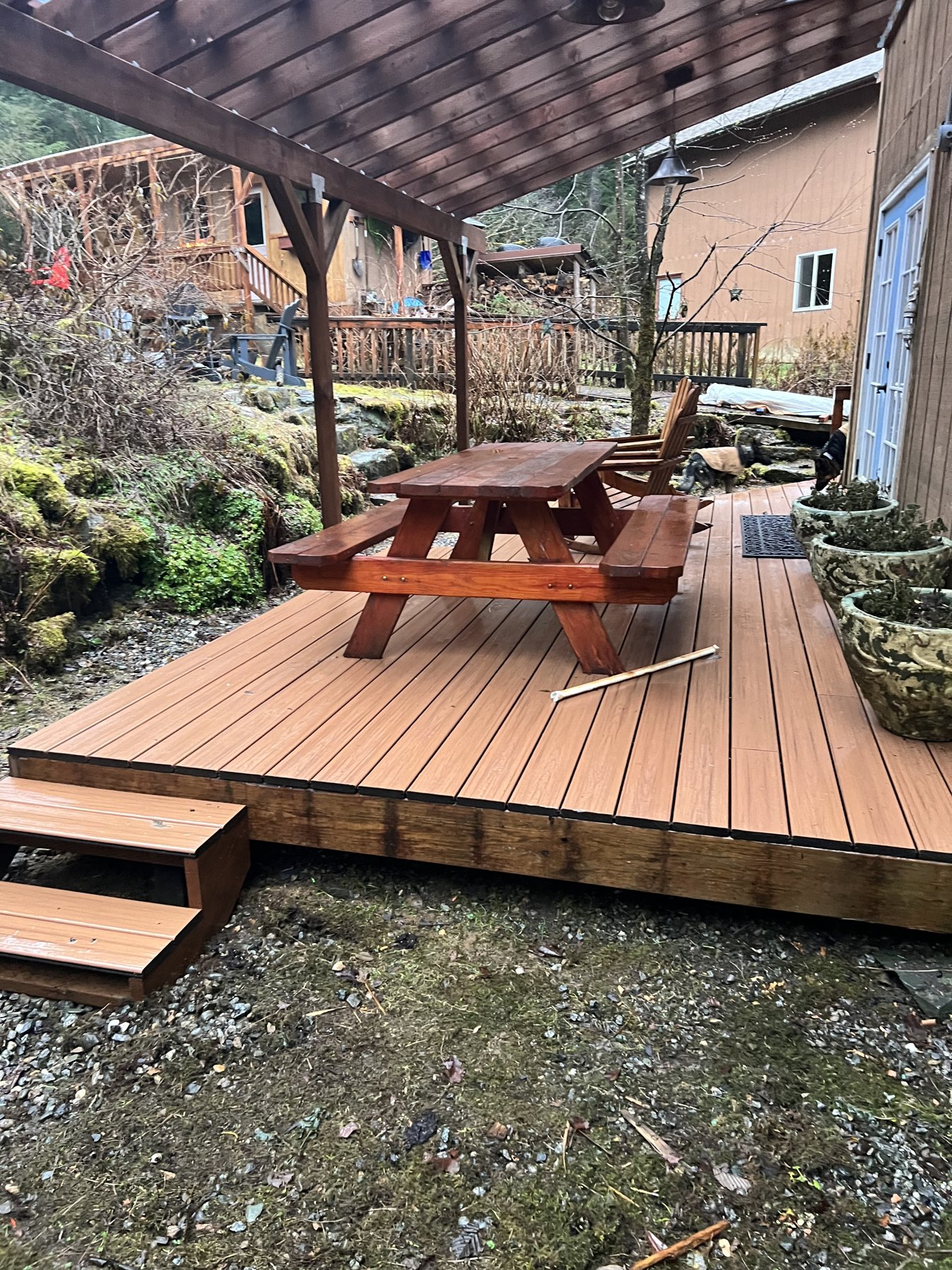 Covered wood deck with steps and outdoor seating