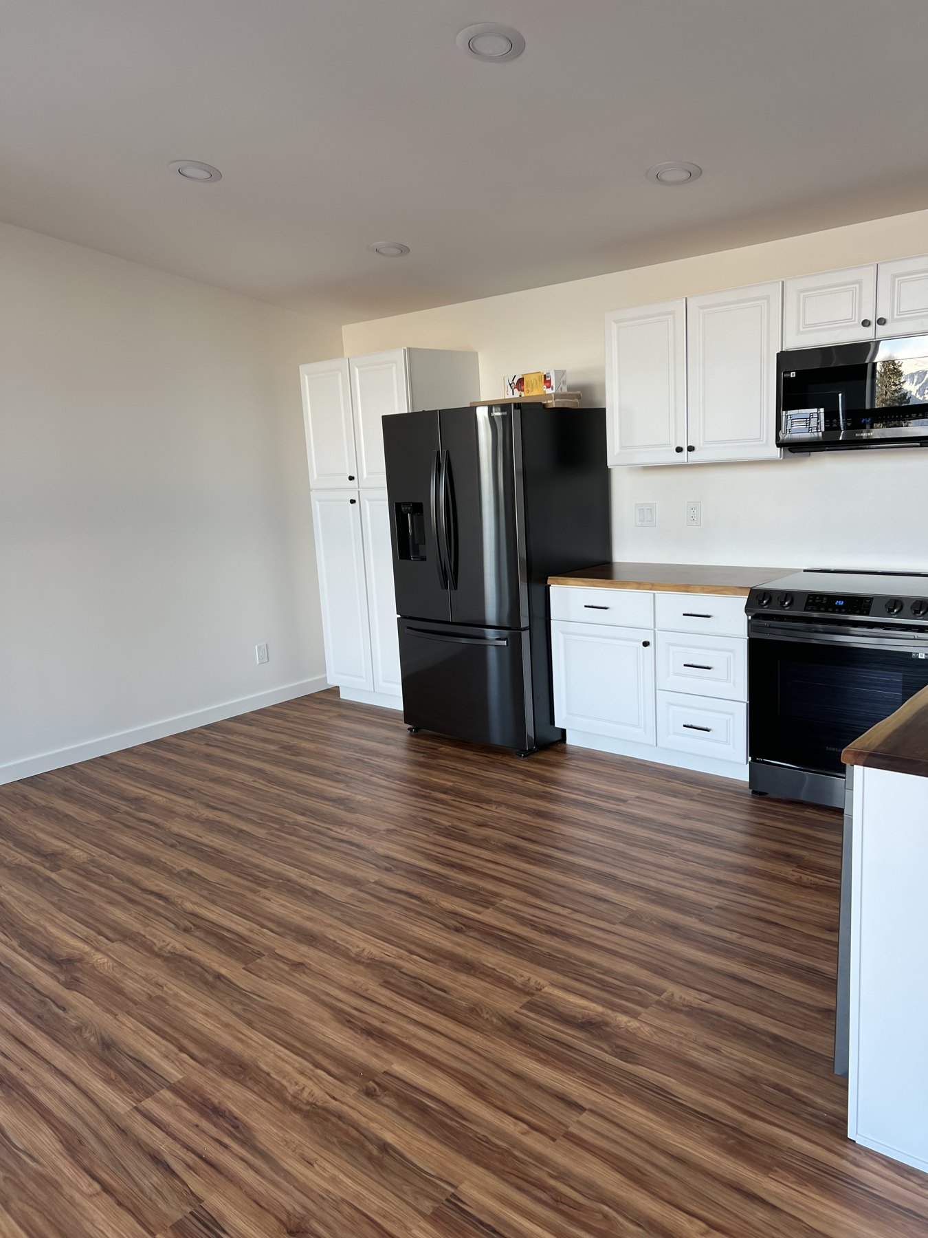 Finished wood-look flooring in an open kitchen and living area
