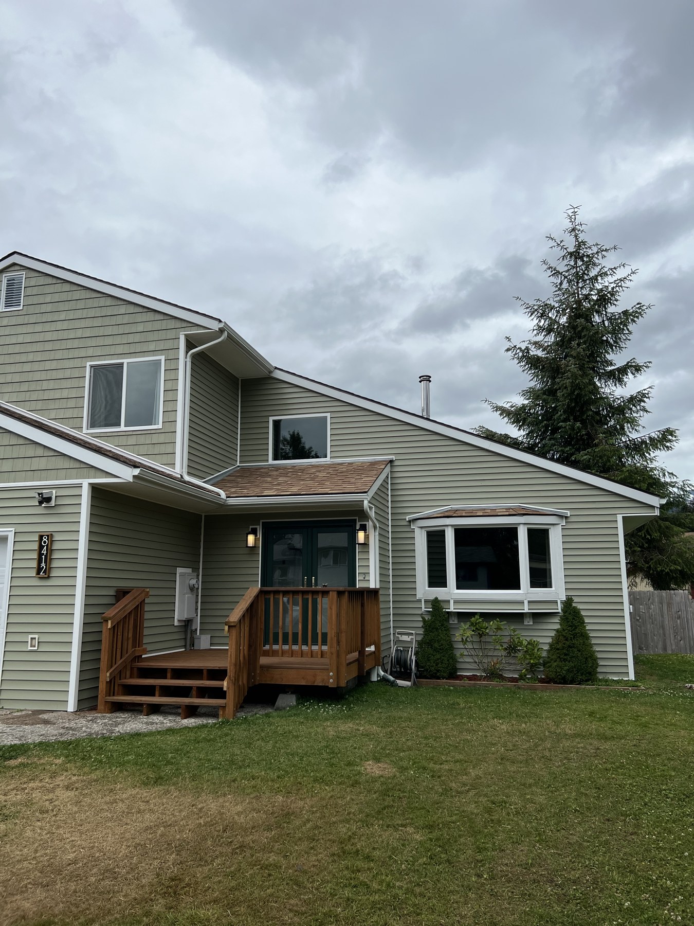 Home exterior with gray siding and a covered front entry