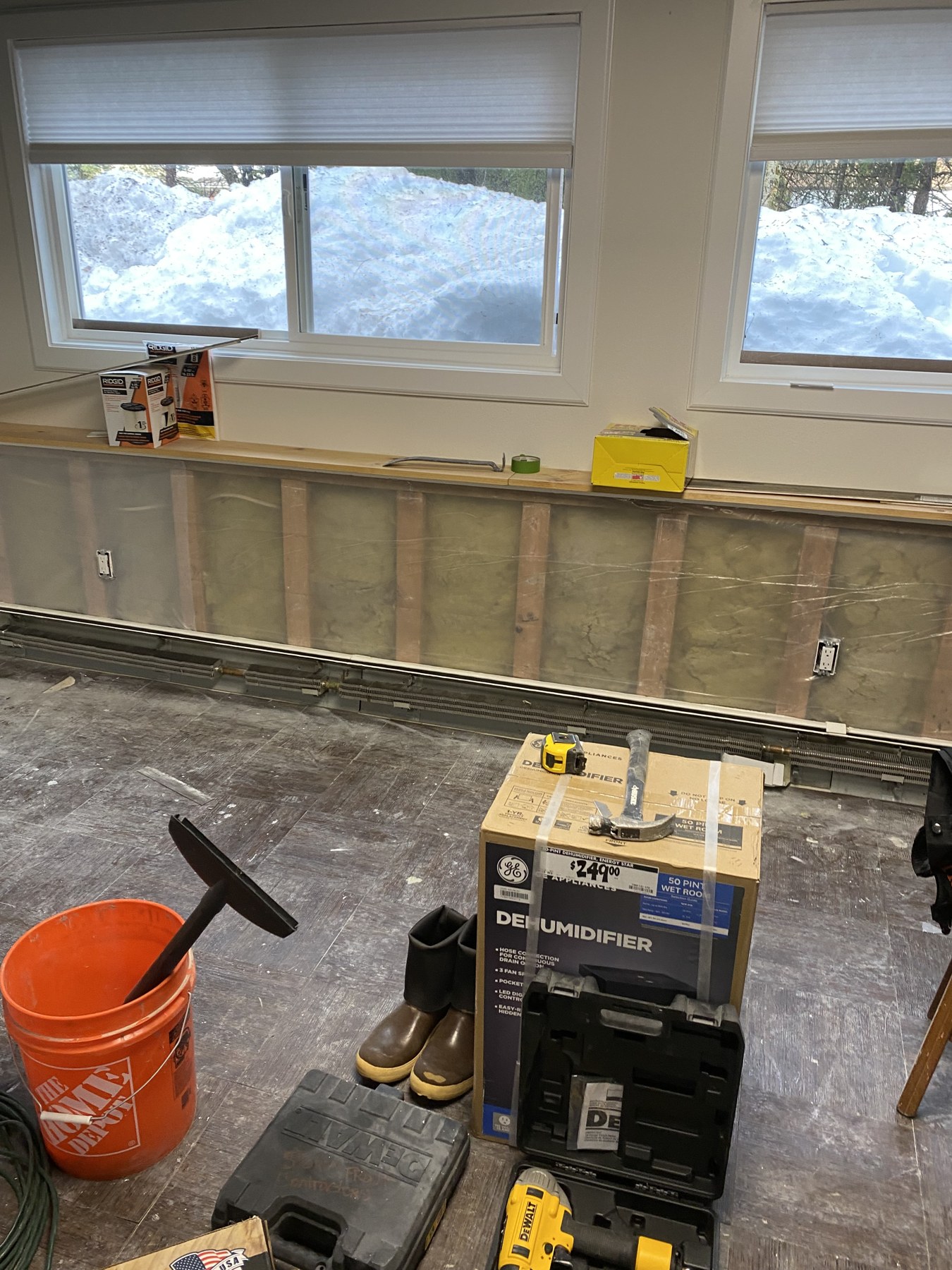 Interior renovation in progress beneath two windows