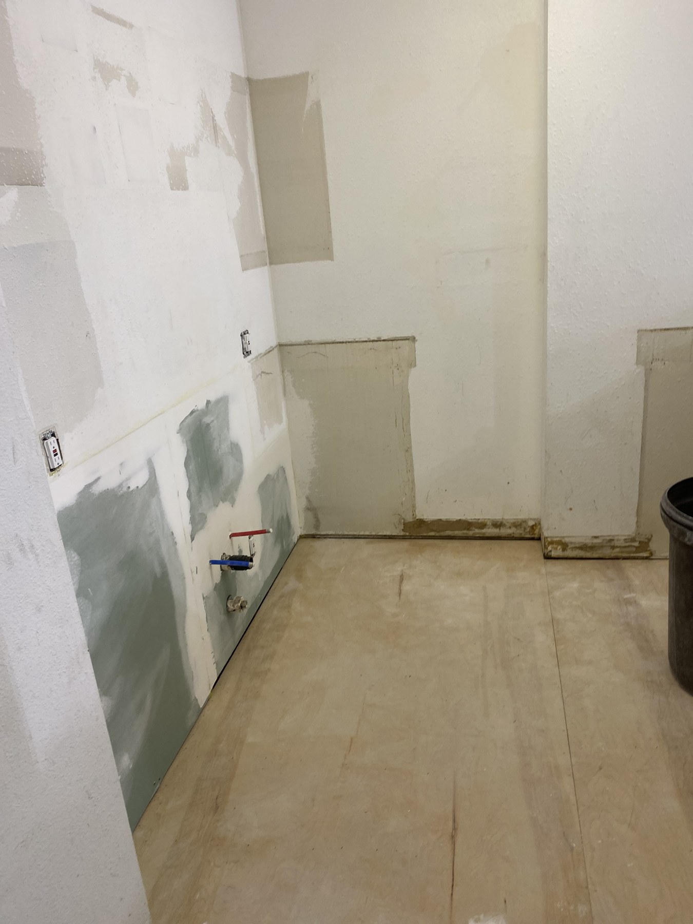 Drywall repairs in a room under renovation