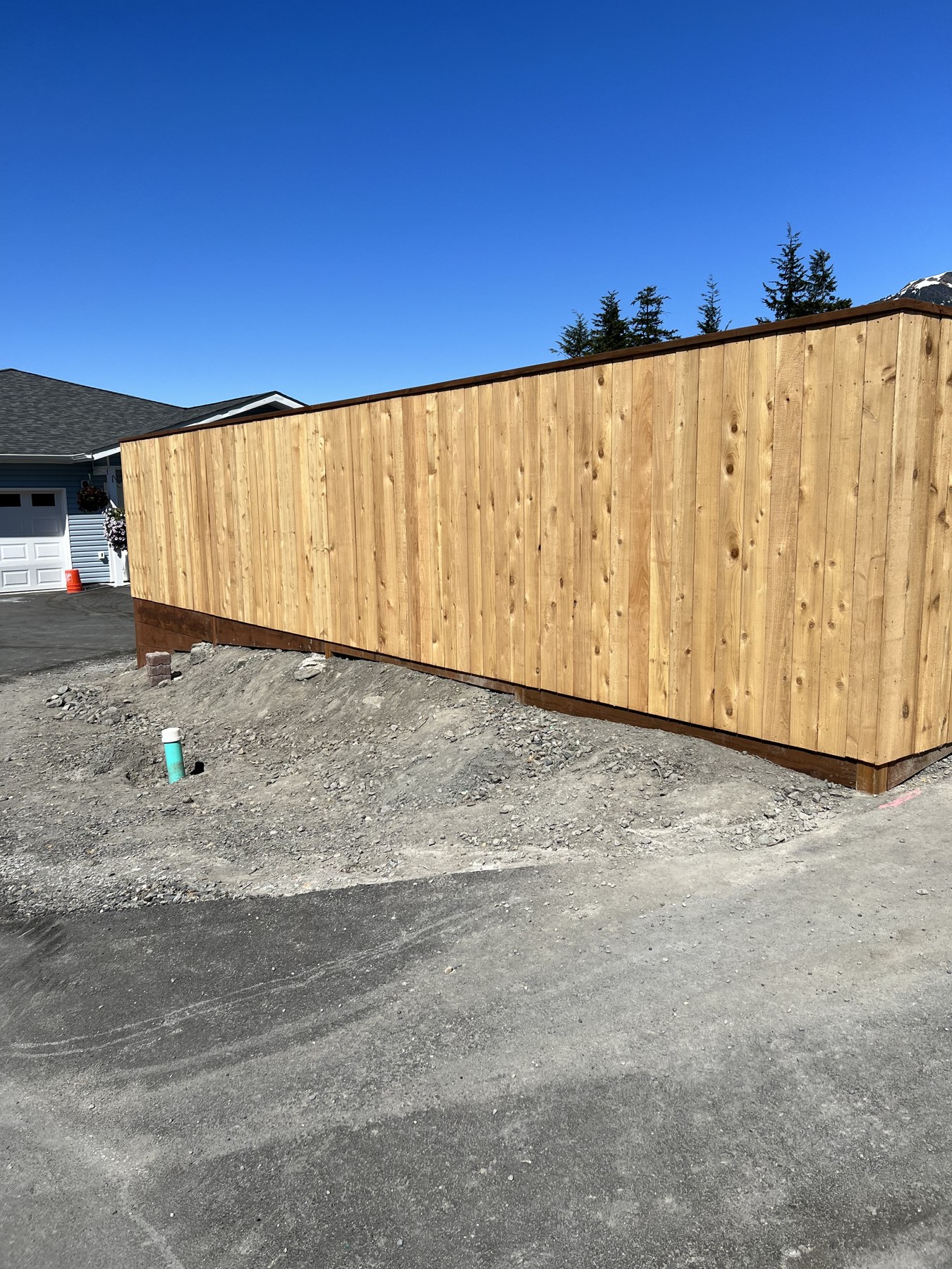 Long wood-sided exterior beside a driveway