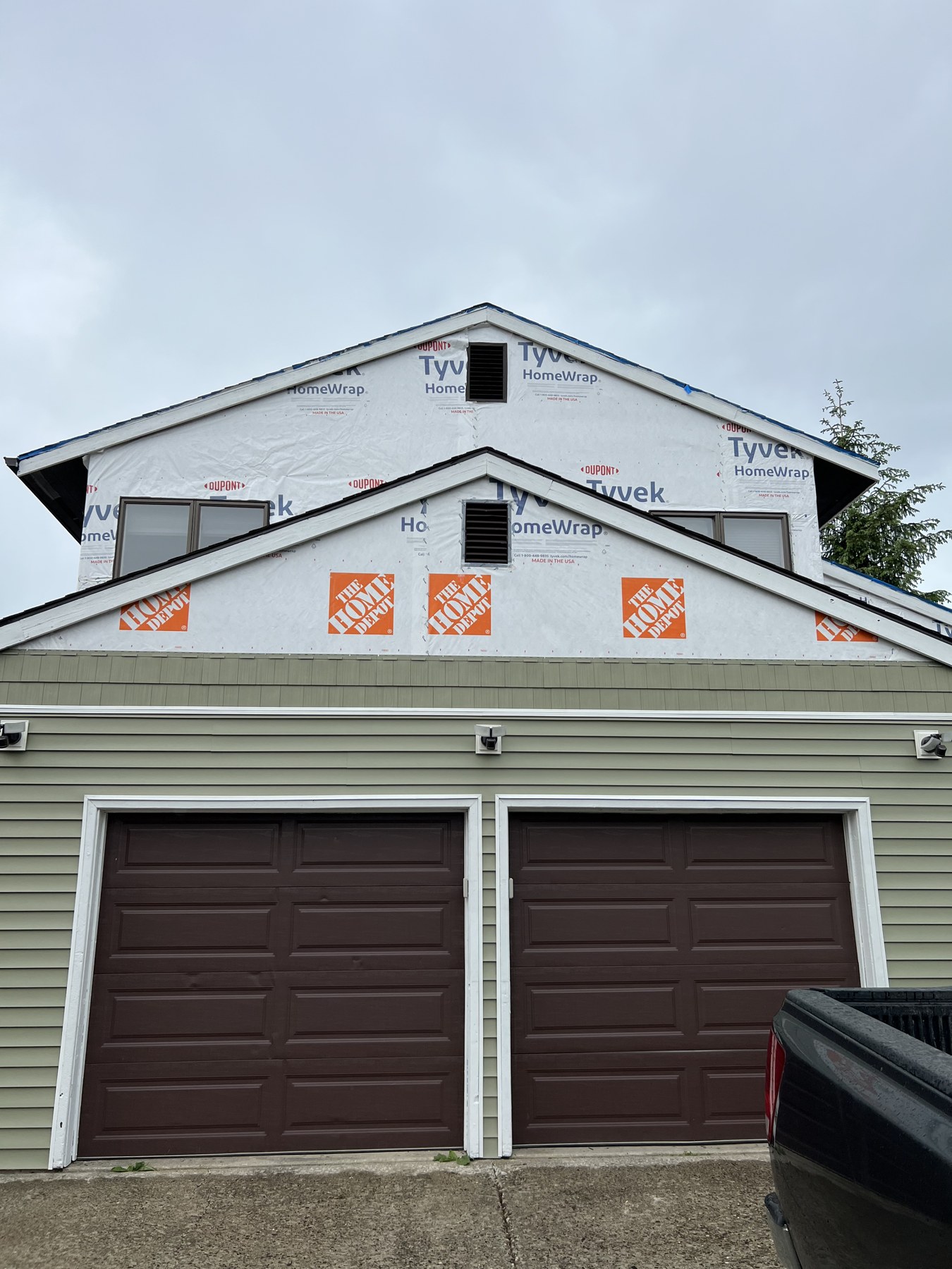 Garage exterior with upper wall renovation in progress