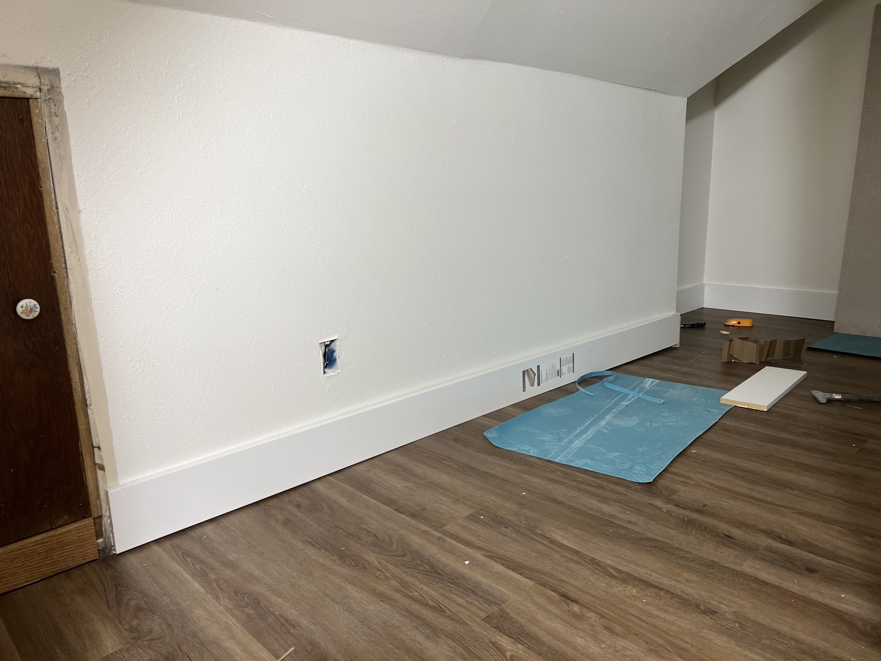Interior room with white walls and wood-look flooring