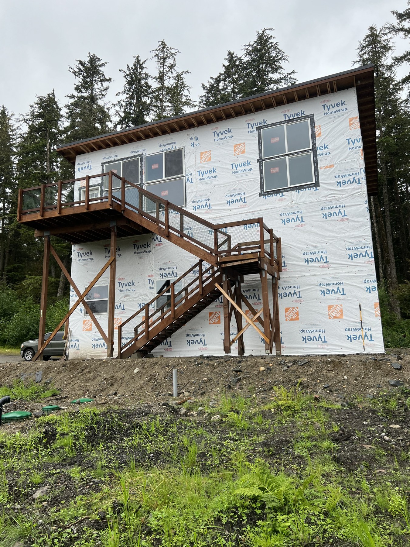 House exterior renovation with a raised deck and stairs