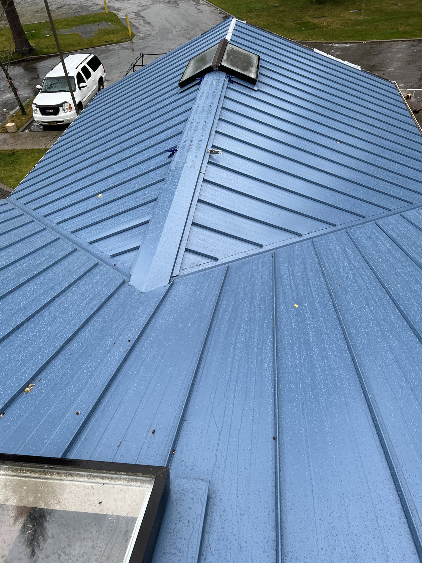 Completed blue metal roof with ridge and vent details