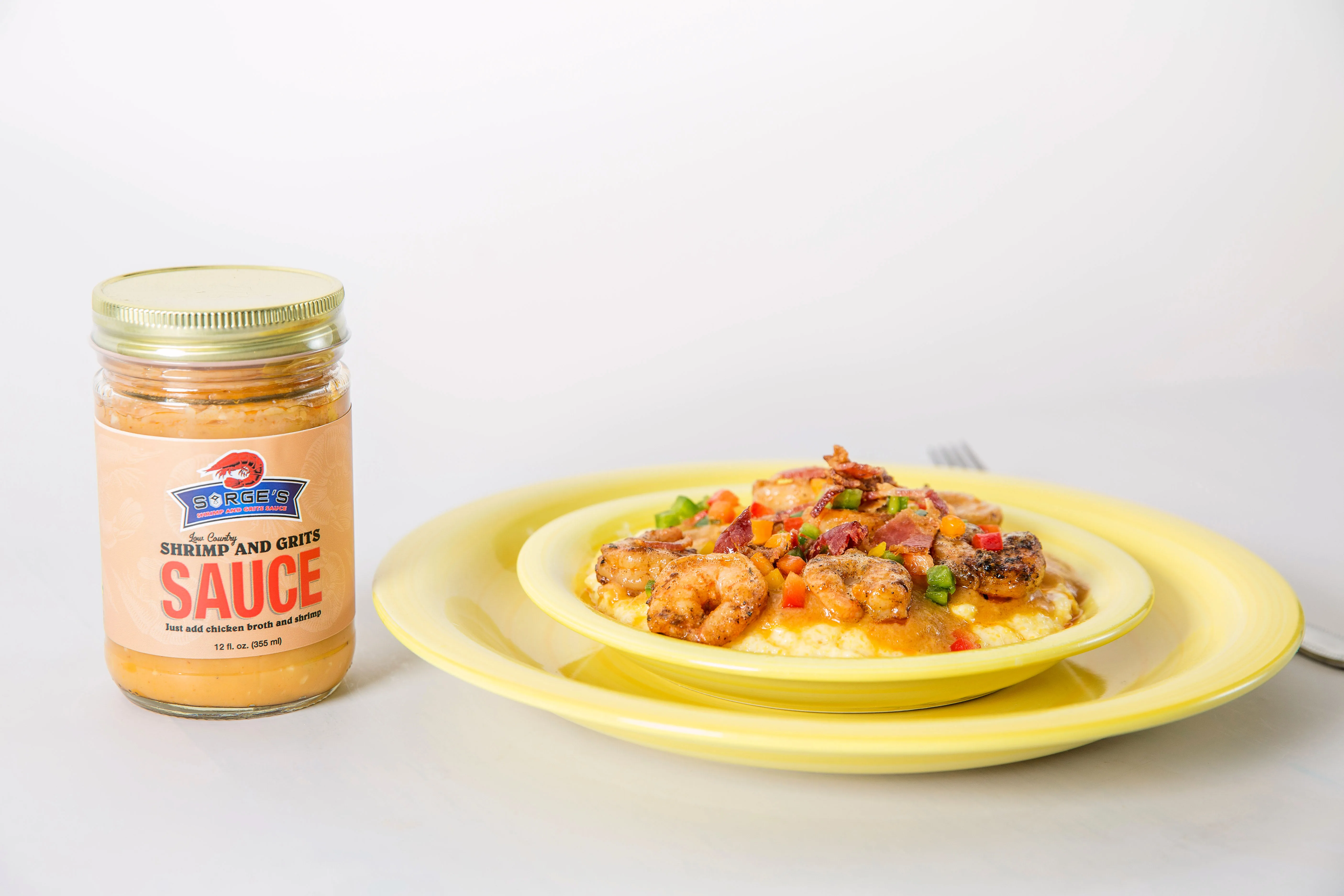 Shrimp and grits plated with Sarge's sauce