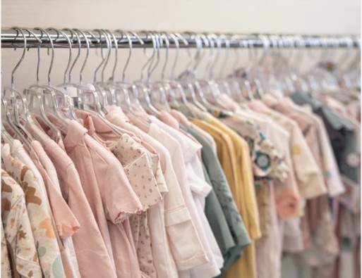 Pastel children’s clothing on the racks at Kiddy Korner