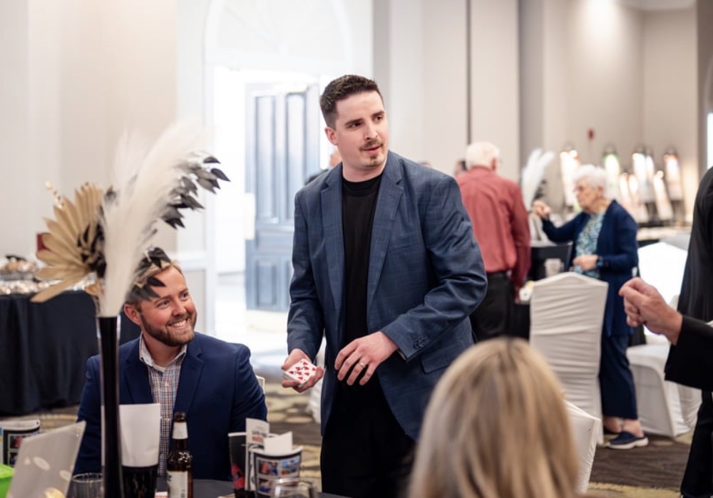 Neal Chamberlain performing close-up magic at a formal event