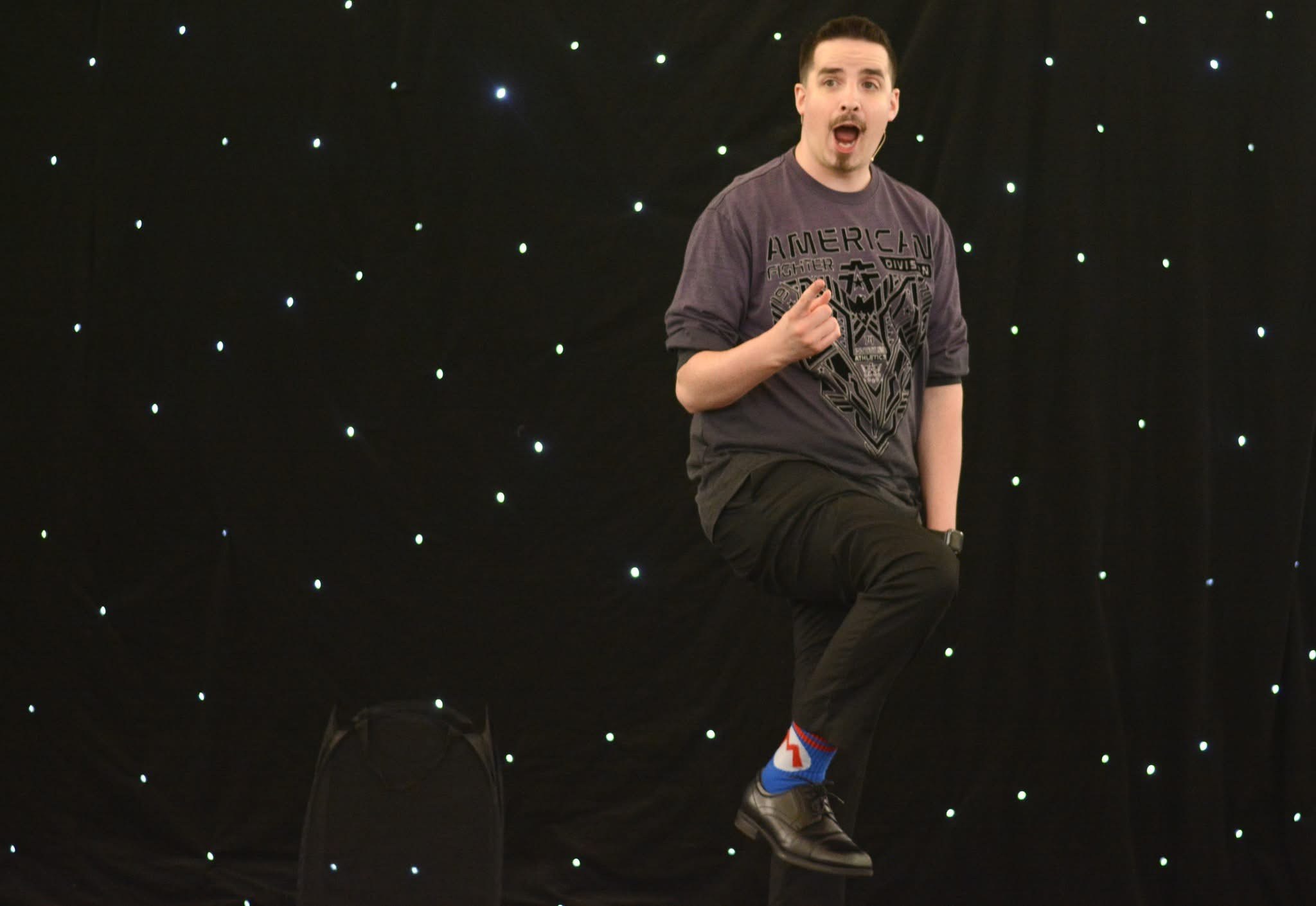 Neal Chamberlain showing a colorful sock during a high-energy library magic moment