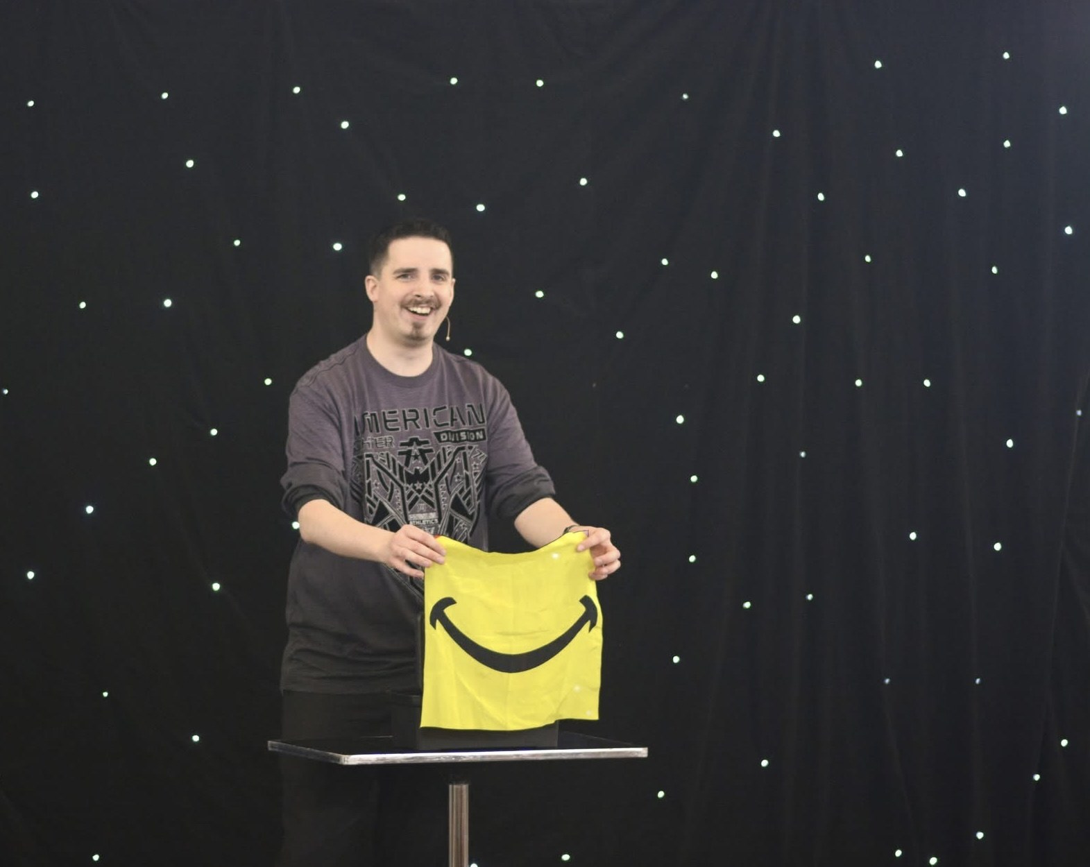 Neal Chamberlain smiling during a school magic performance