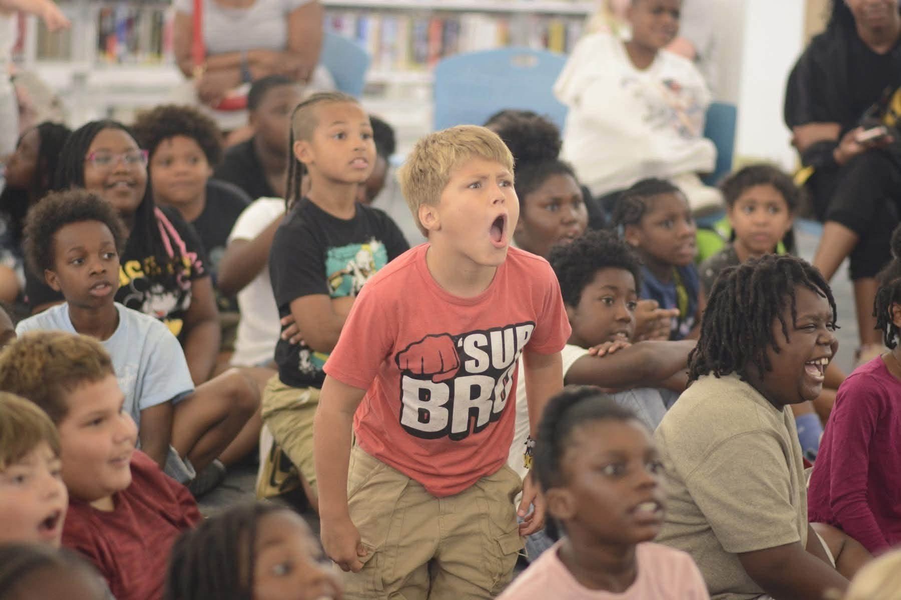 Students reacting together during a live school magic program