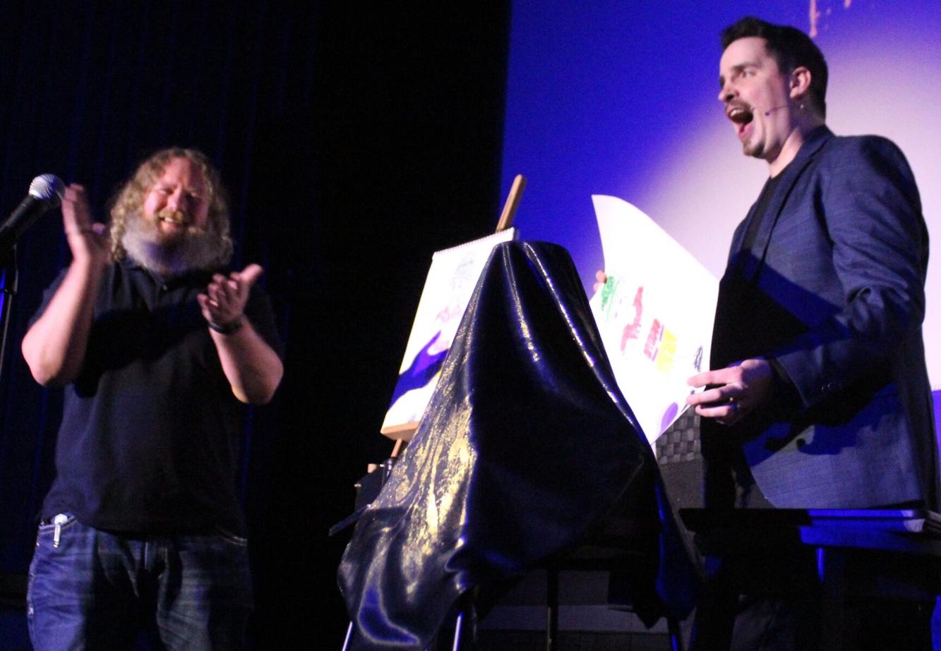 Neal Chamberlain performing a live illusion with an engaged theater volunteer