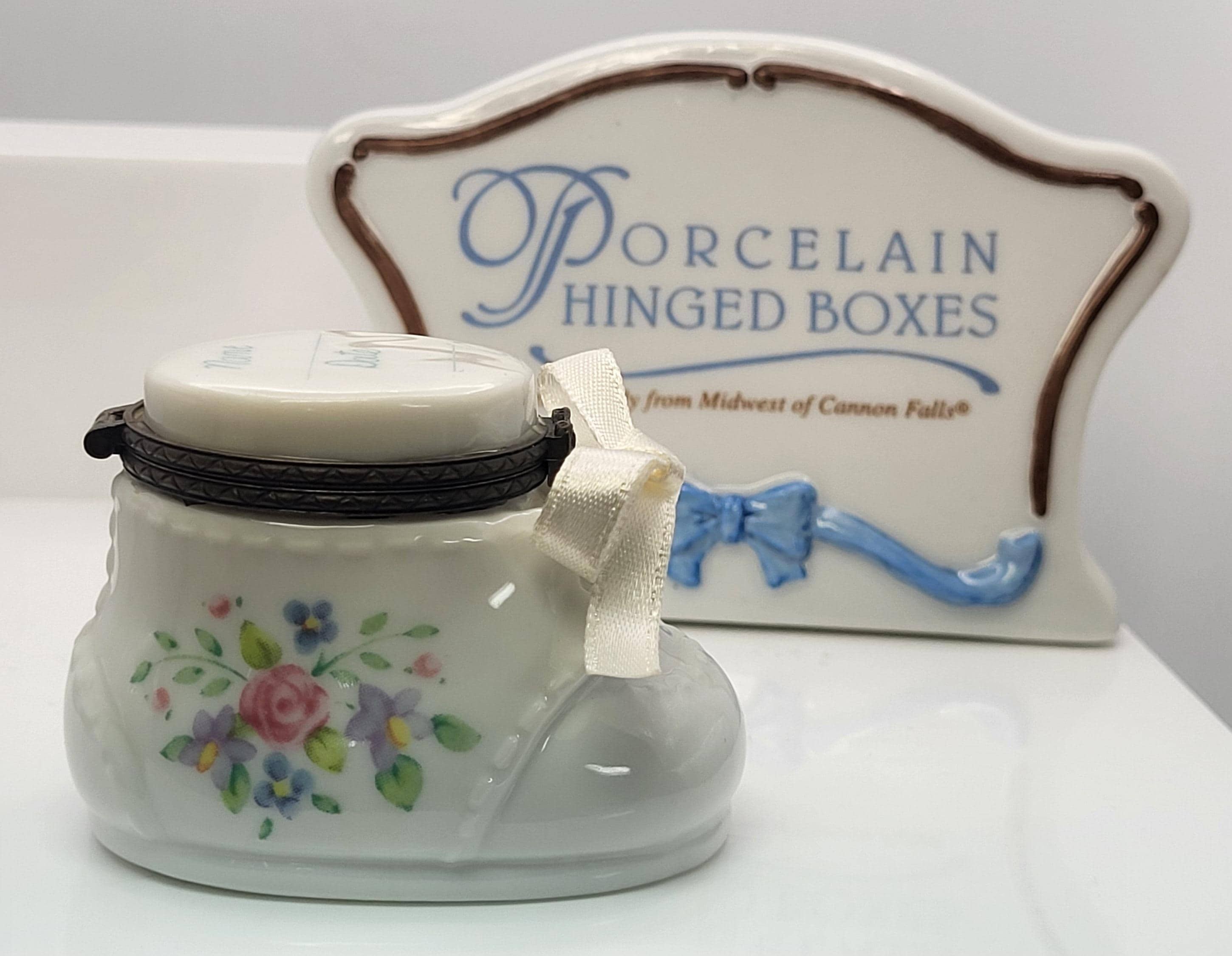 Baby shoe porcelain hinged trinket box. Made by Midwest of Cannon Falls.