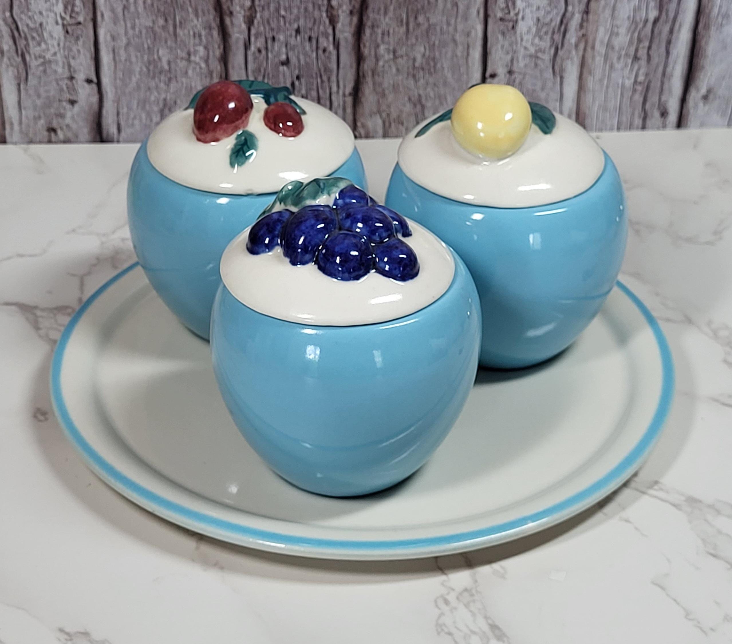 Set of three vintage, MCM jelly/jam jars sitting on a serving plate. Made by Abingdon. view 2