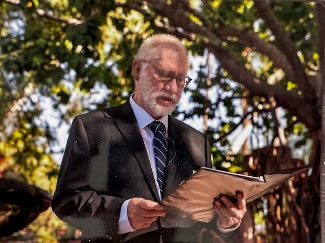 Edward Elster officiating an outdoor wedding ceremony