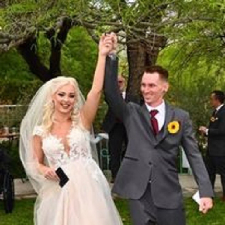 A newly married couple celebrating outdoors