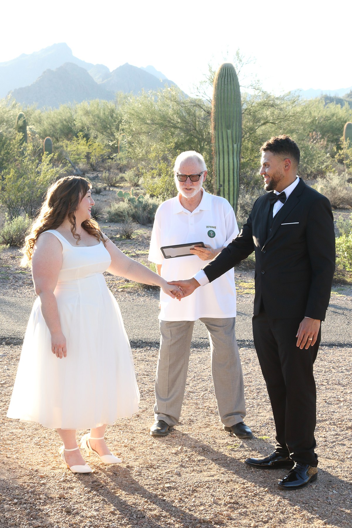 A couple holding hands during their desert ceremony