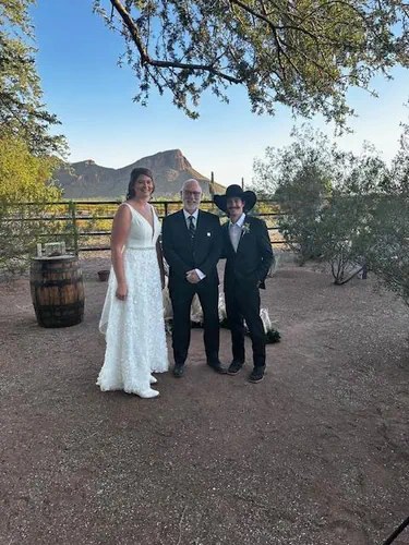 Edward with a couple at a desert wedding