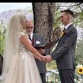 A couple holding hands during an outdoor ceremony