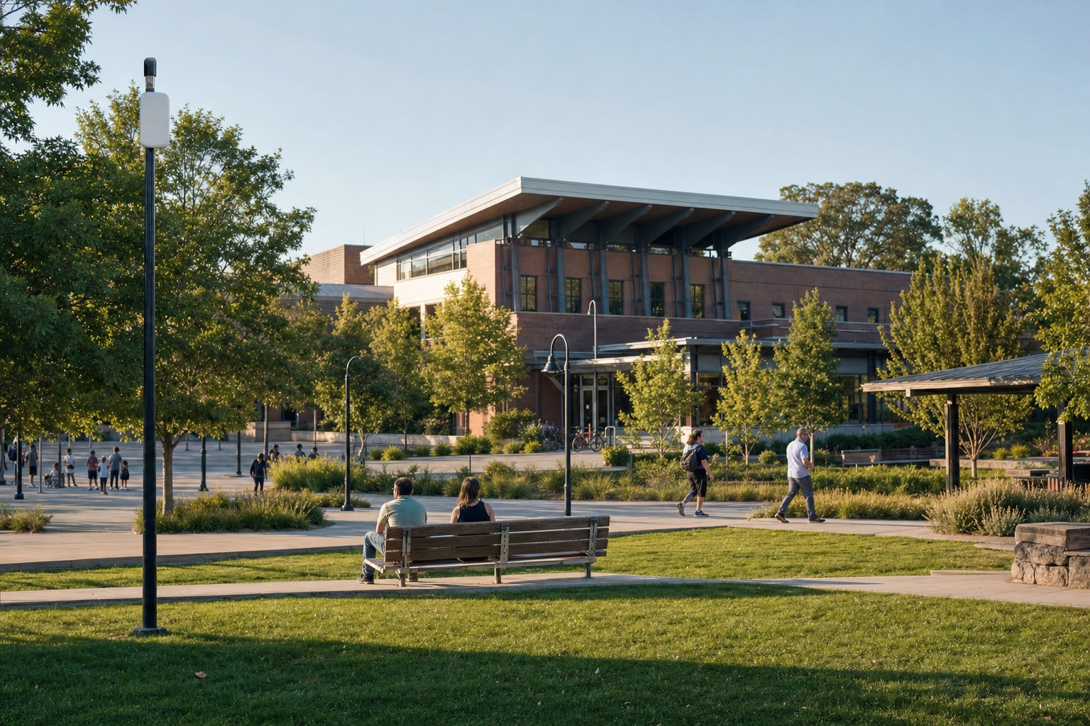 A civic park and public library with an outdoor wireless access point serving a gathering area