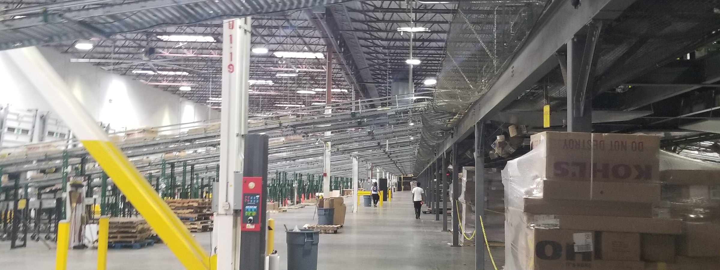 Industrial facility with elevated conveyor systems and electrical infrastructure