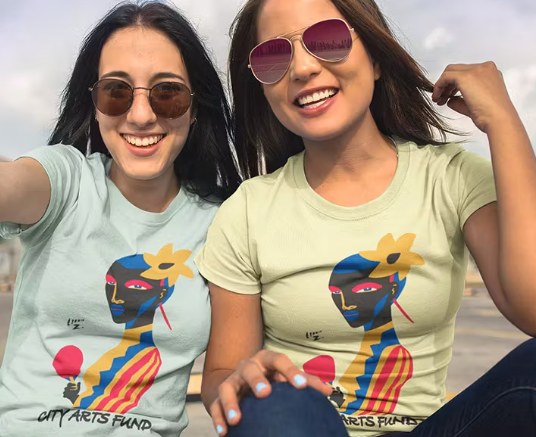 Two women wearing colorful custom graphic shirts