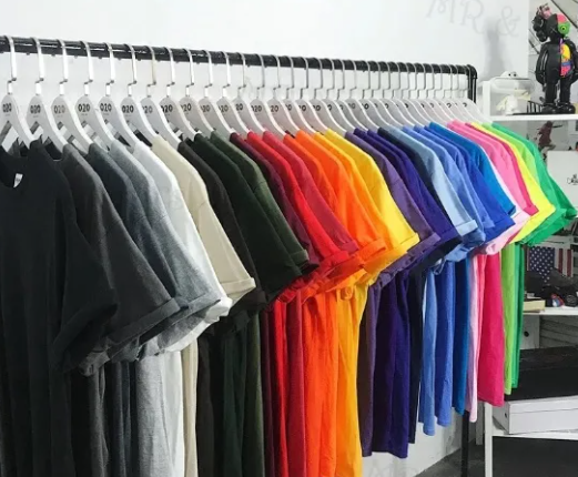 Colorful T-shirts arranged on a clothing rack