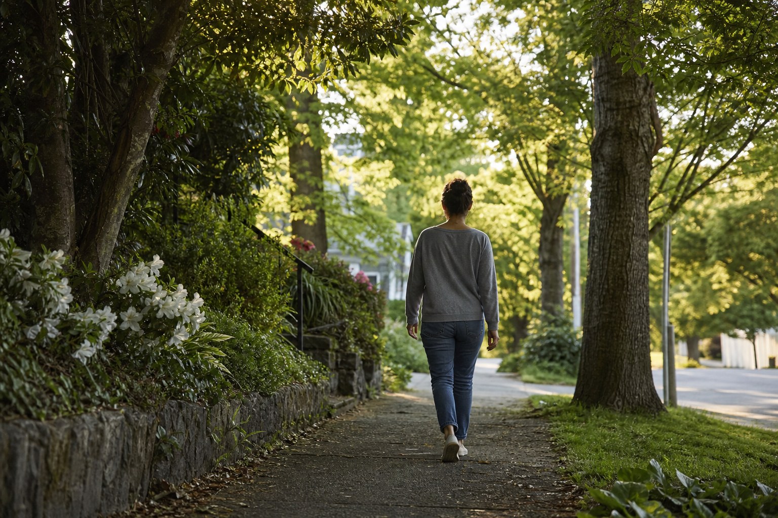 Person taking a gentle walk on a leafy neighborhood path