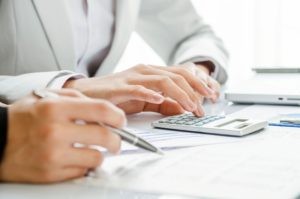 People reviewing documents and calculations