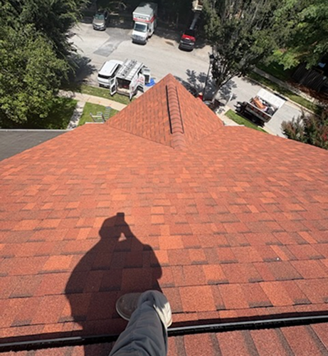 Close view of red roof shingles during roofing work
