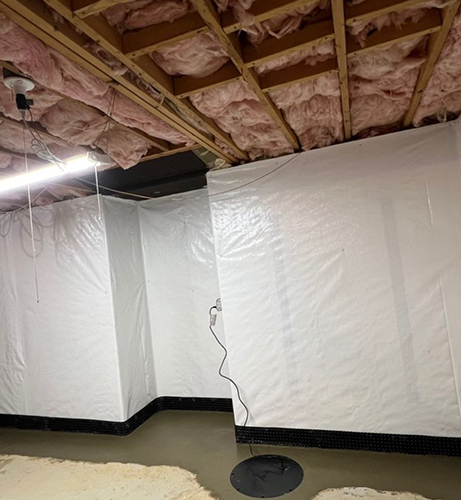 Basement waterproofing membrane and sump basin beneath exposed ceiling joists