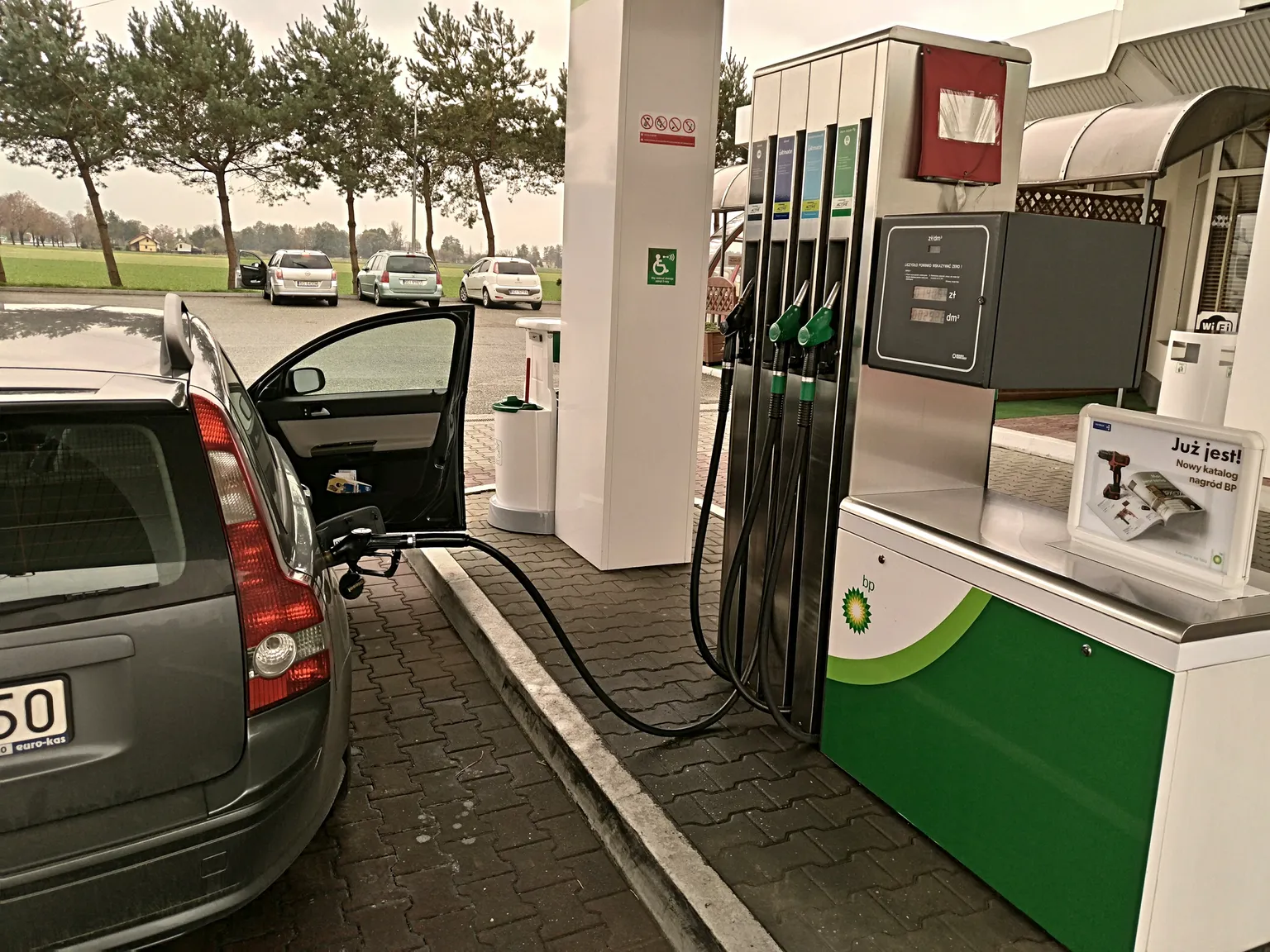Car parked beside a fuel pump after refueling