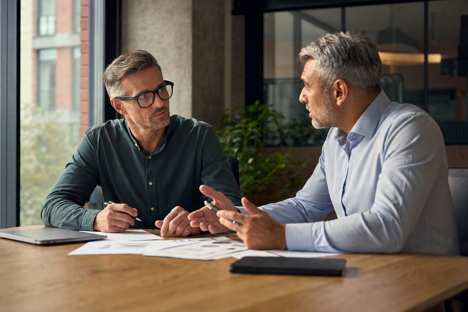 Business owner and technology advisor discussing a service proposal