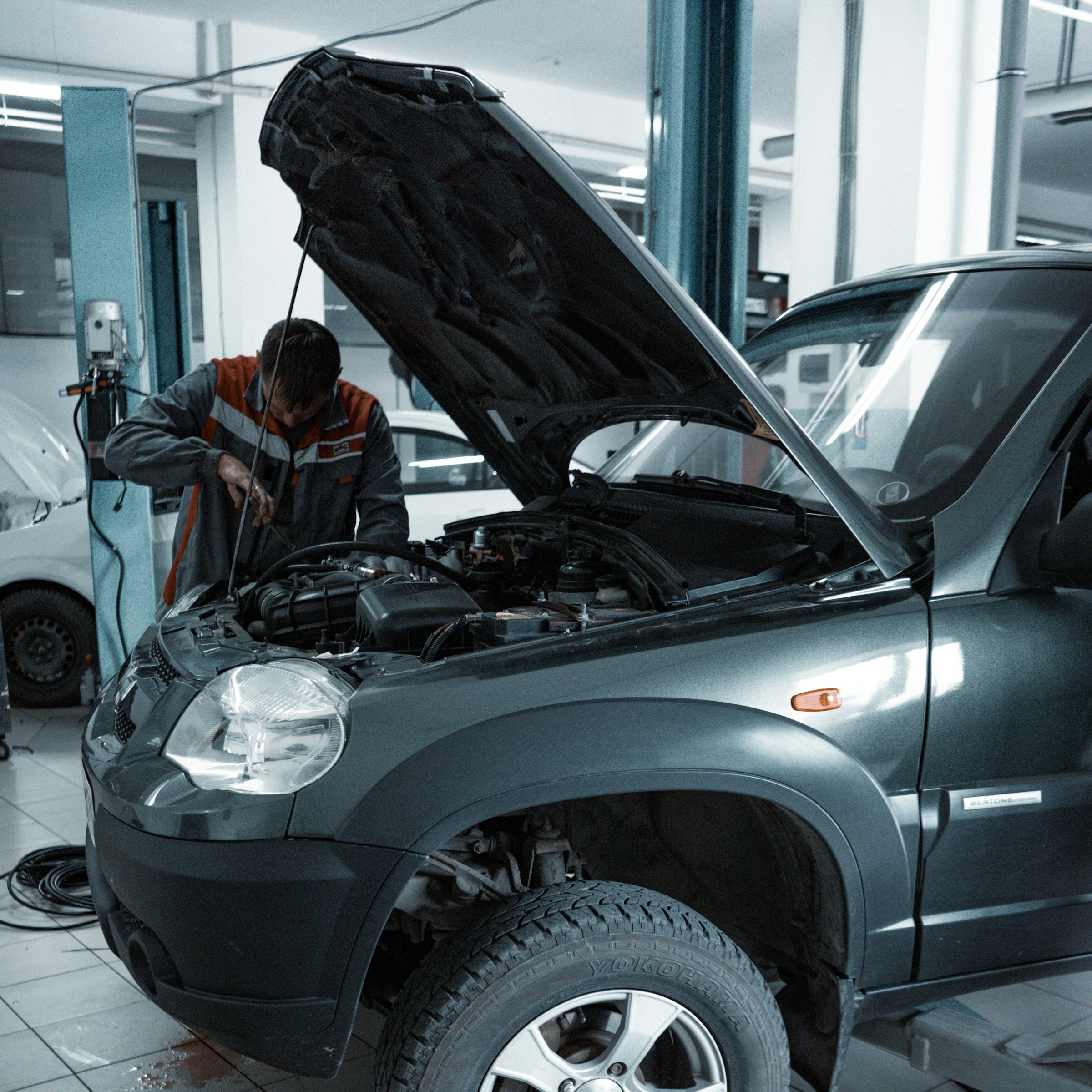 Mechanic servicing a vehicle in a modern auto repair shop