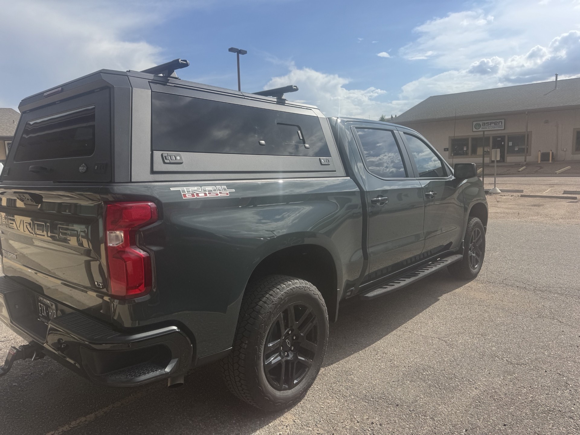 Chevrolet Silverado with a Peakline aluminum truck cap and roof bars